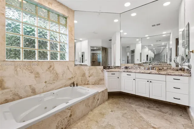 a bathroom with a shower sink and mirror