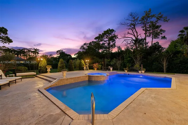 a view of a swimming pool with lounge chairs