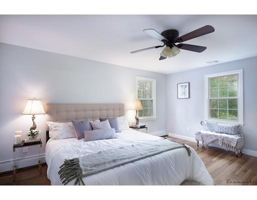 17 Mill Run Road Boxford, MA 01921 - Photo 19 of 26 a bedroom with a bed and wooden floor