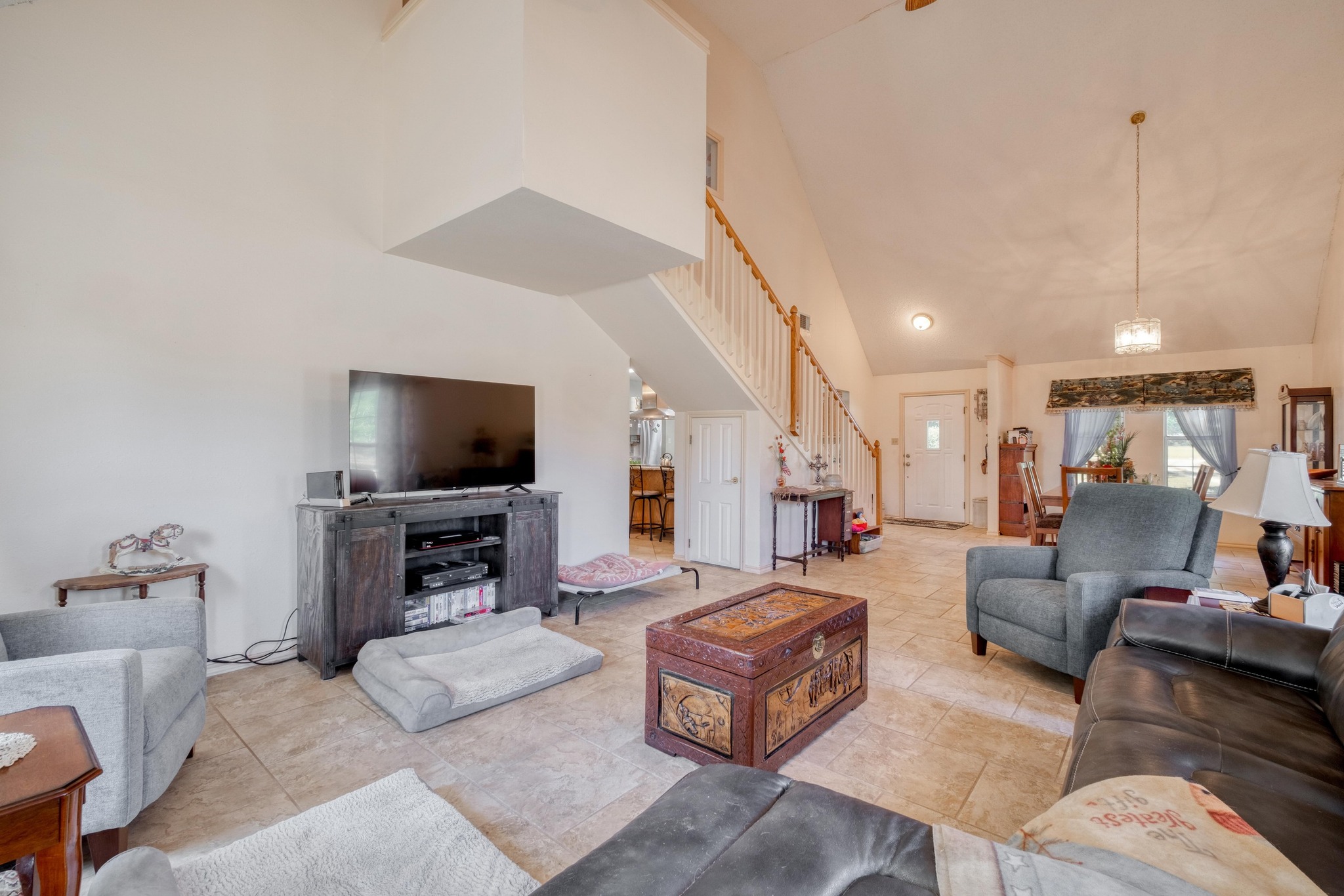 153 Pleasant Grove Road Elgin, TX 78621 - Photo 8 of 34 Living area featuring high vaulted ceiling and stairway