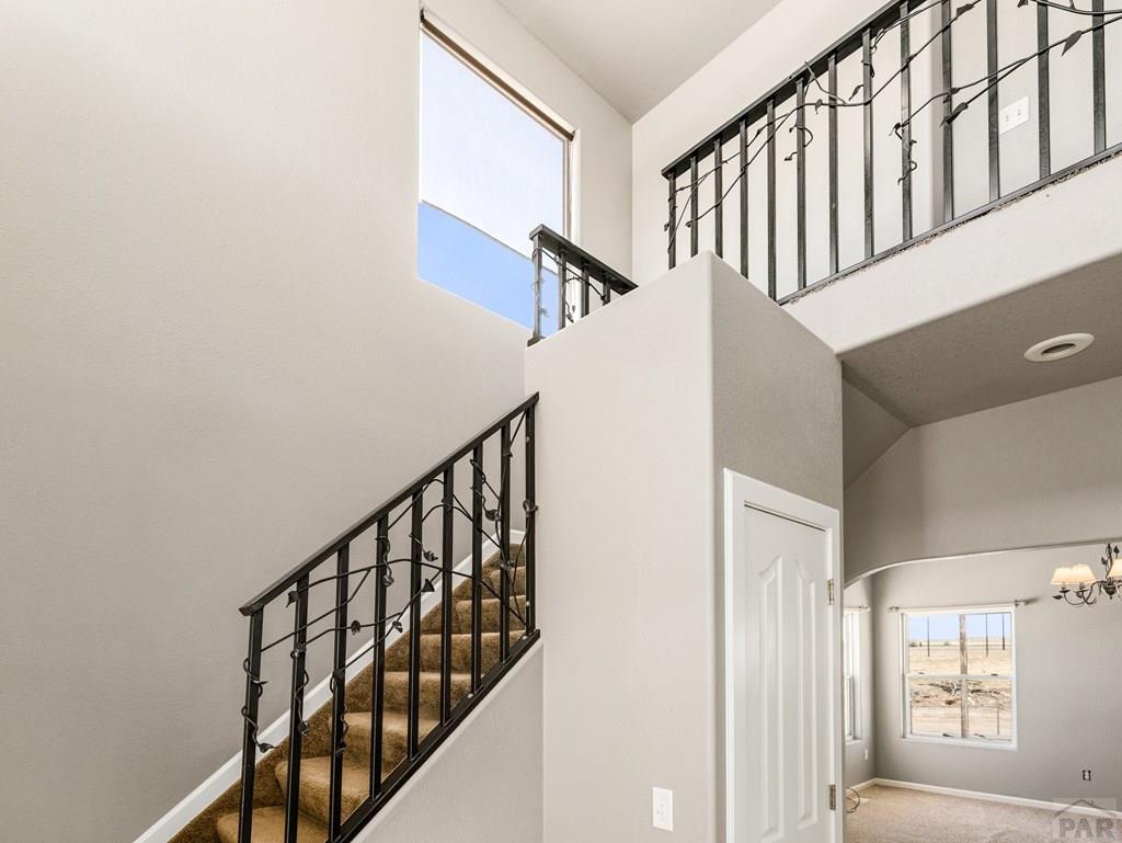 43948 Hunsaker Road Avondale, CO 81022 - Photo 17 of 56 a view of staircase with lots of frames on wall and a window