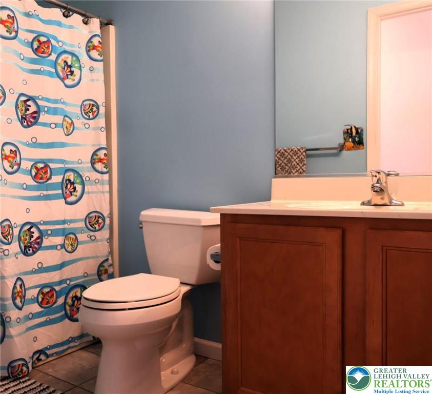 396 Anthony Drive Northampton, PA 18067 - Photo 25 of 35 a bathroom with a toilet and shower curtain