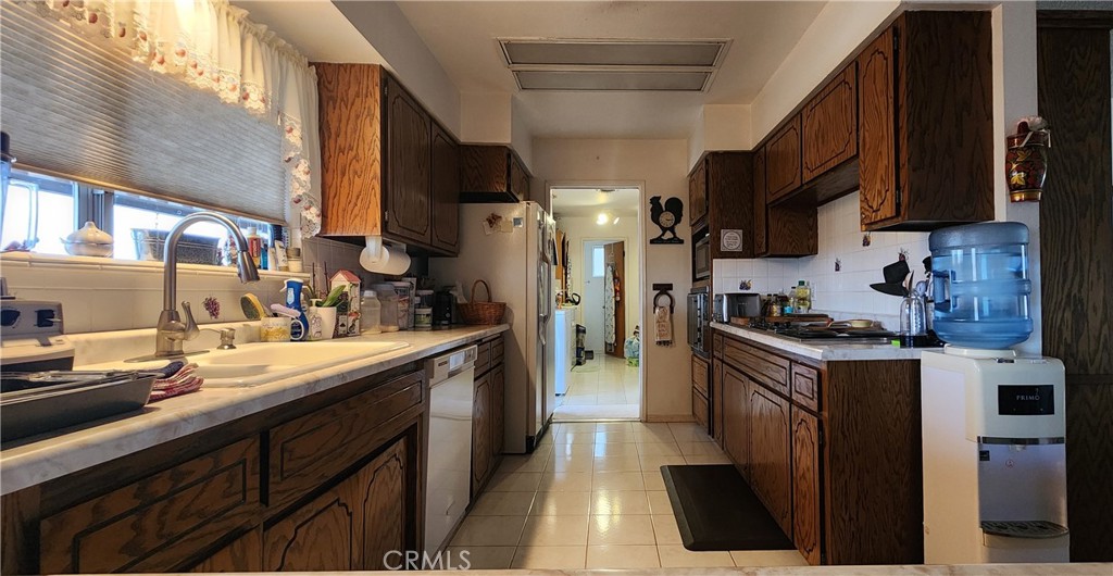 12491 Toby Lane Blythe, CA 92225 - Photo 11 of 41 a kitchen with stainless steel appliances granite countertop a sink a stove and a refrigerator