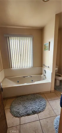 a bedroom with a bed and a mirror