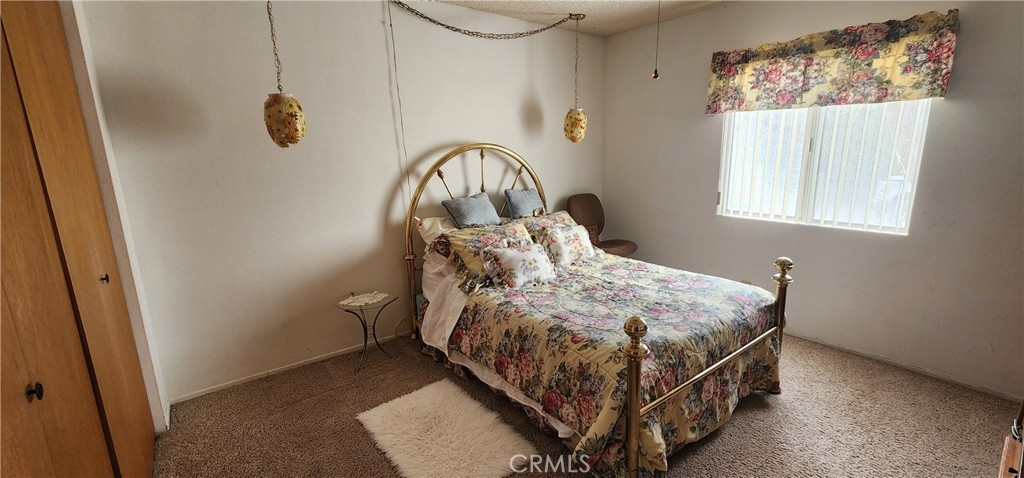 12491 Toby Lane Blythe, CA 92225 - Photo 16 of 41 a bed sitting in a bedroom next to a window