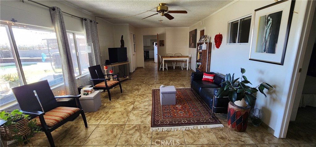 12491 Toby Lane Blythe, CA 92225 - Photo 20 of 41 a living room with furniture and a flat screen tv