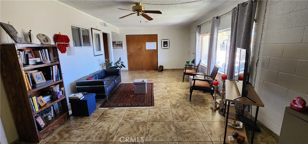 12491 Toby Lane Blythe, CA 92225 - Photo 21 of 41 a living room with furniture a bookshelf and a window