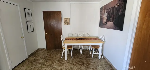a hallway with a large window and wooden floor