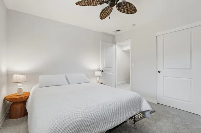 a bedroom with a bed and chandelier