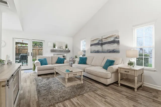 a living room with furniture large window and a table