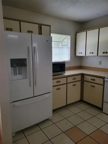 a kitchen with stainless steel appliances a refrigerator sink and cabinets
