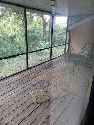 a view of a balcony with wooden floor