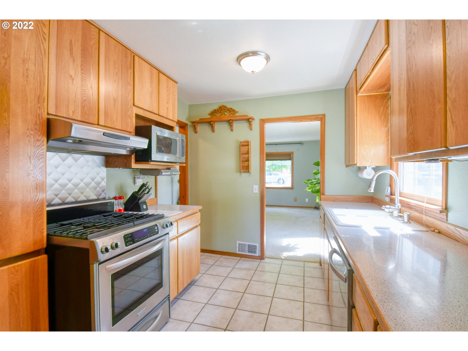 2917 Southwest Ladow Avenue Pendleton, OR 97801 - Photo 11 of 31 a kitchen with stainless steel appliances granite countertop a stove a sink and a refrigerator