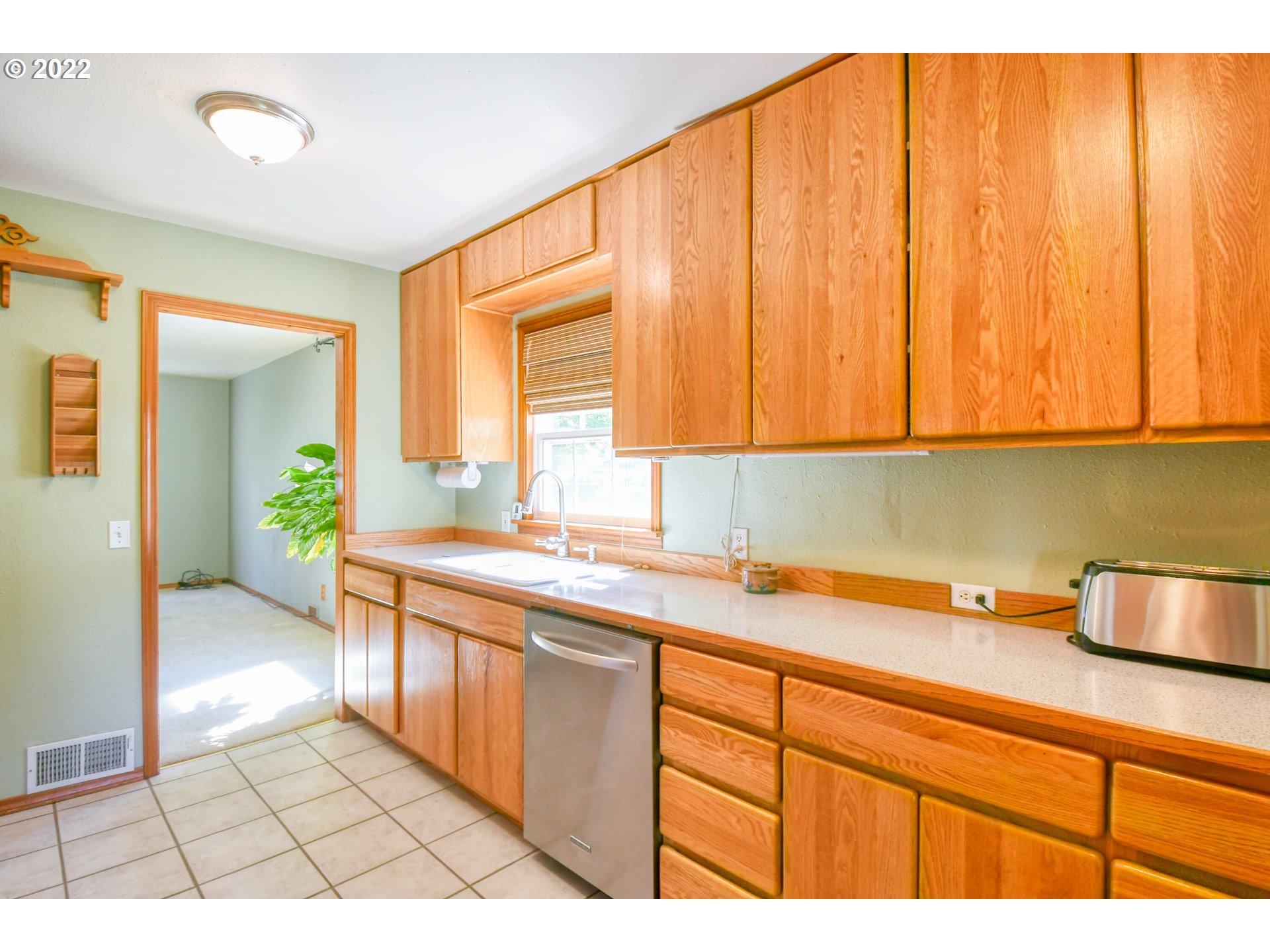 2917 Southwest Ladow Avenue Pendleton, OR 97801 - Photo 12 of 31 a kitchen with a sink a stove cabinets and a window