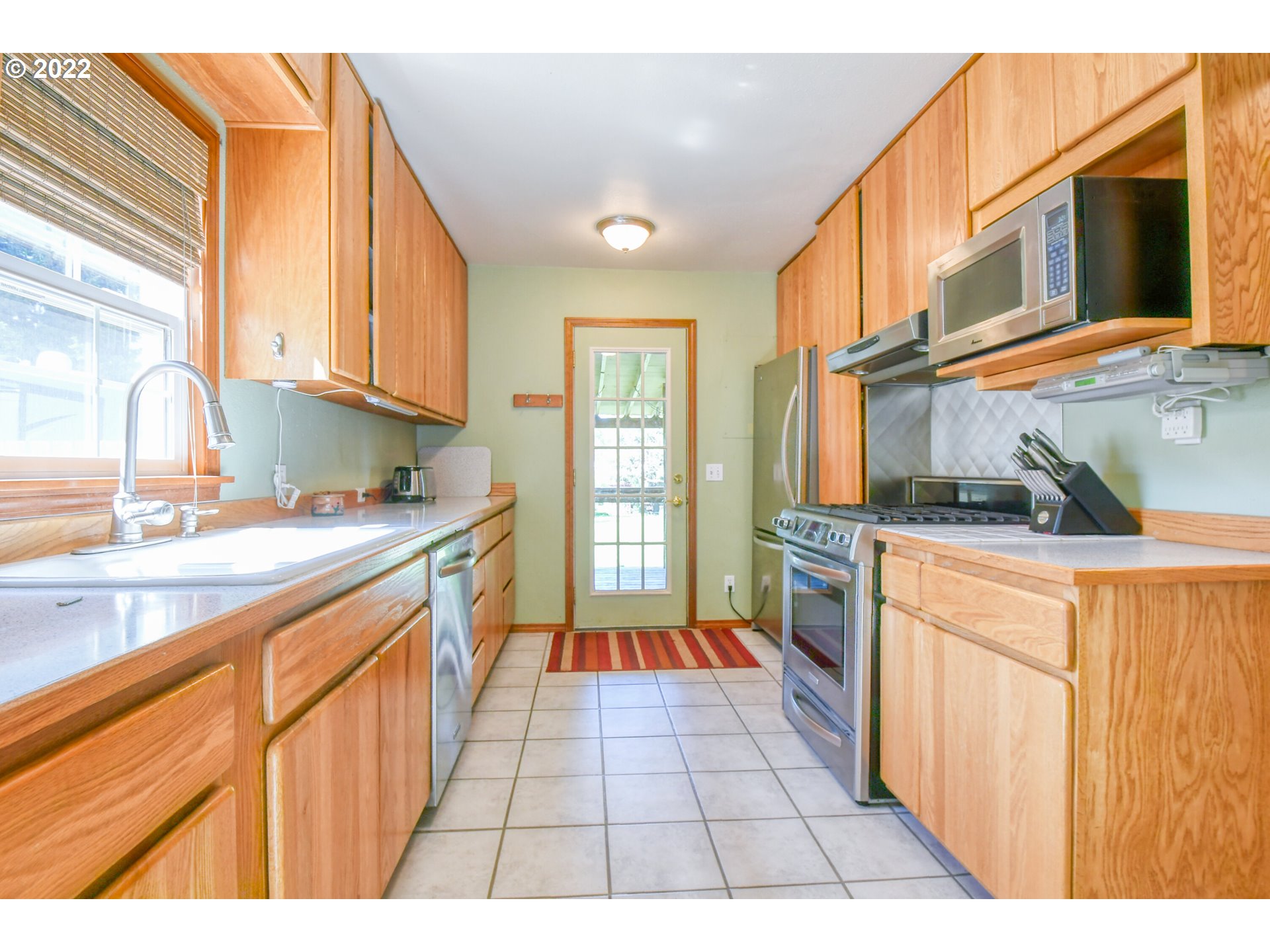 2917 Southwest Ladow Avenue Pendleton, OR 97801 - Photo 13 of 31 a kitchen with a sink a counter top space and cabinets
