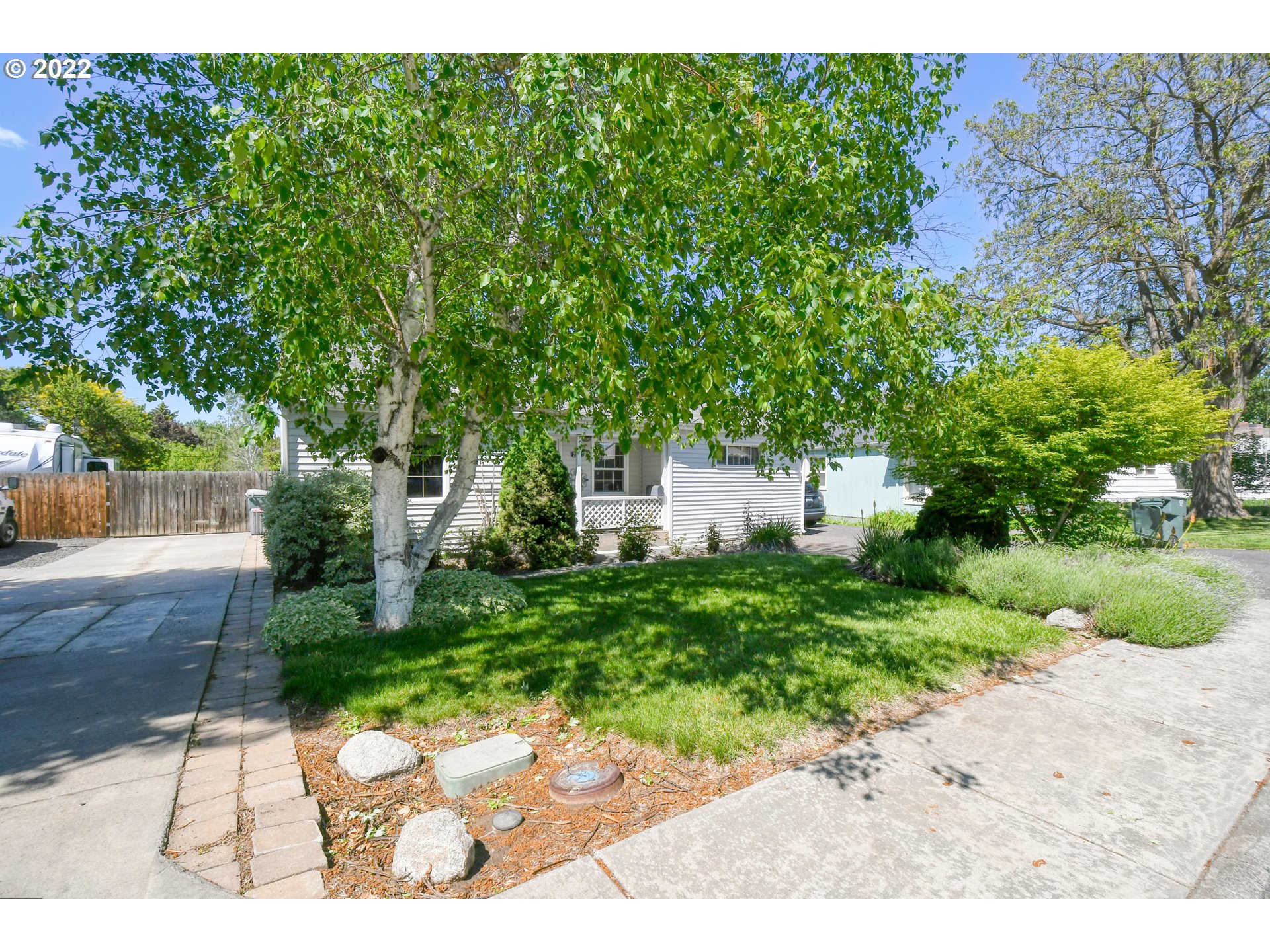 2917 Southwest Ladow Avenue Pendleton, OR 97801 - Photo 2 of 31 a backyard of a house with a garden and plants