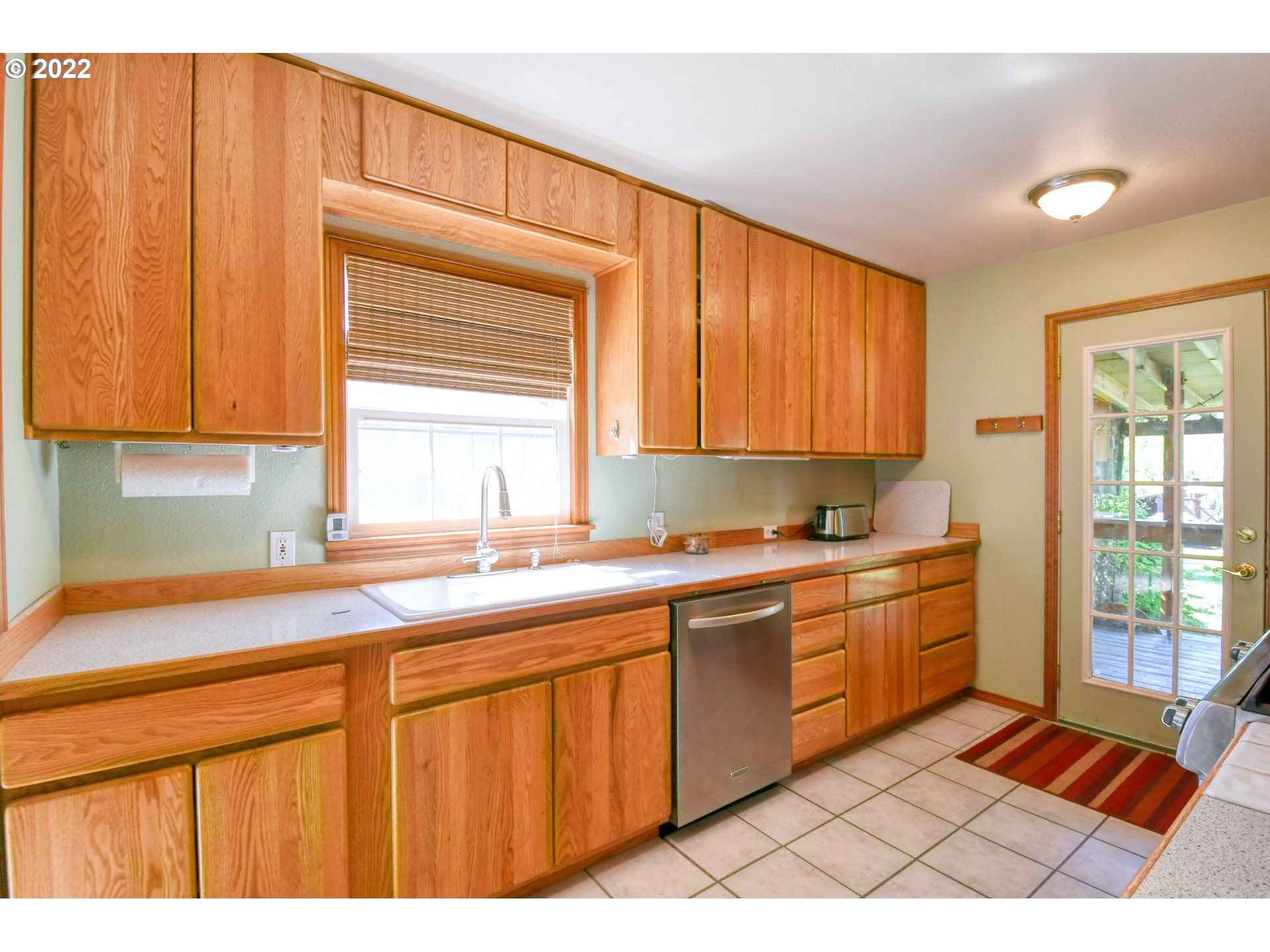 2917 Southwest Ladow Avenue Pendleton, OR 97801 - Photo 9 of 31 a kitchen with stainless steel appliances granite countertop a sink cabinets and a window