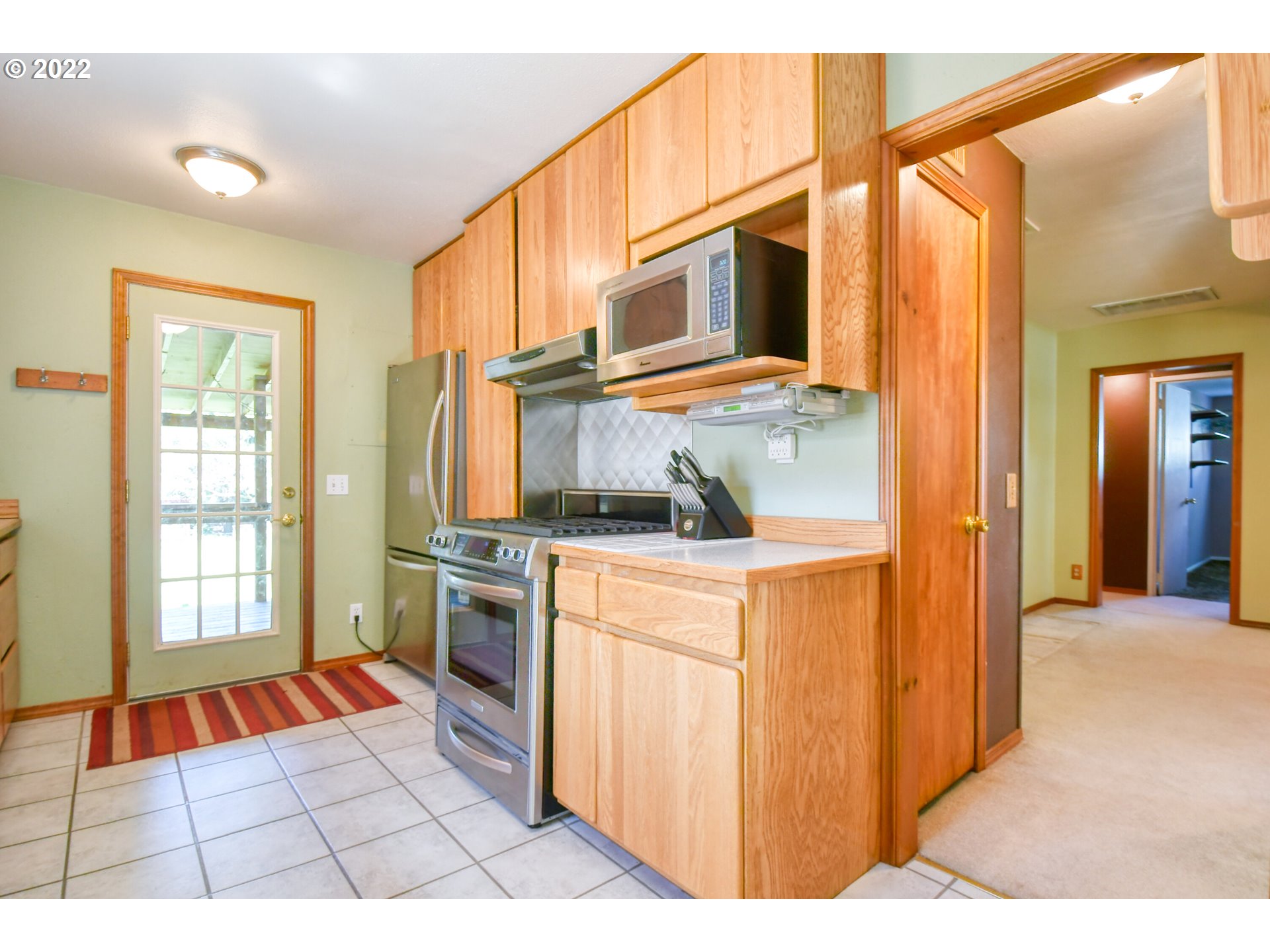 2917 Southwest Ladow Avenue Pendleton, OR 97801 - Photo 10 of 31 a open kitchen with stainless steel appliances granite countertop a refrigerator and a stove top oven