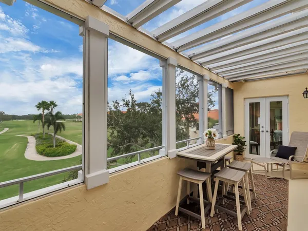 a dining room with furniture and a floor to ceiling window