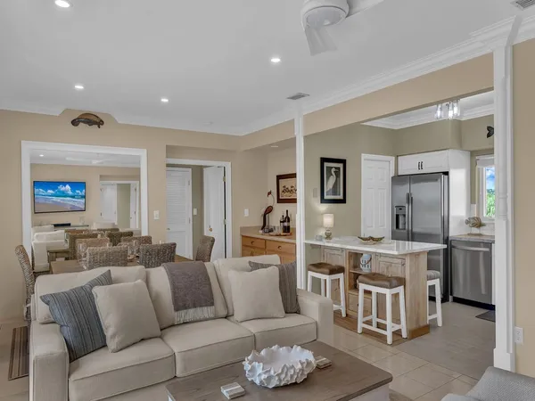 a living room with stainless steel appliances kitchen island granite countertop furniture and a view of kitchen