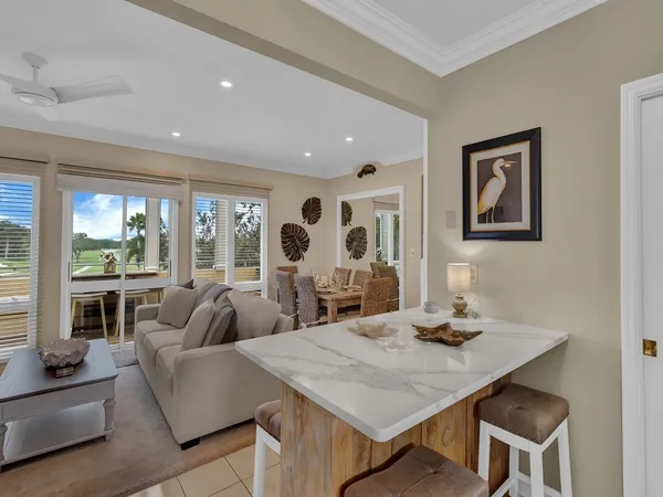 a living room with furniture and large windows