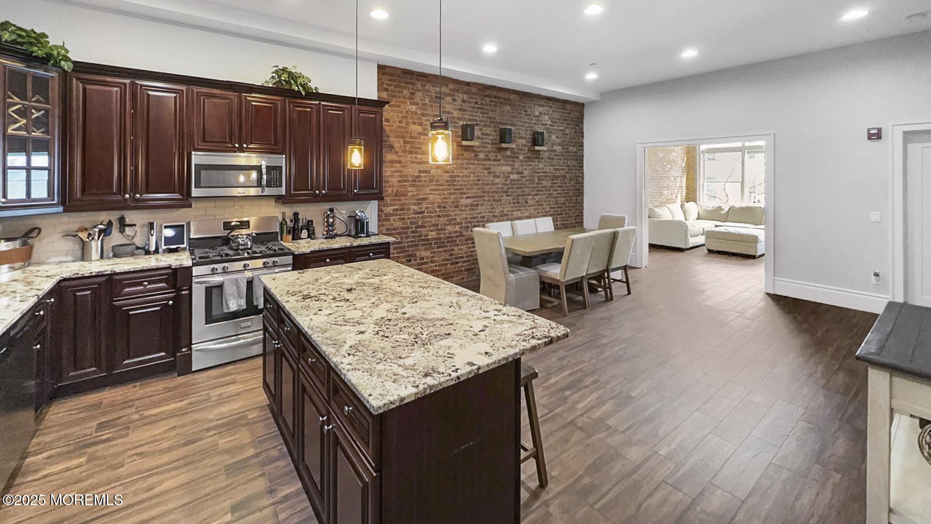 18 Broad Street, Unit 2F Red Bank, NJ 07701 - Photo 3 of 13 a kitchen with a stove a sink a refrigerator and wooden cabinets