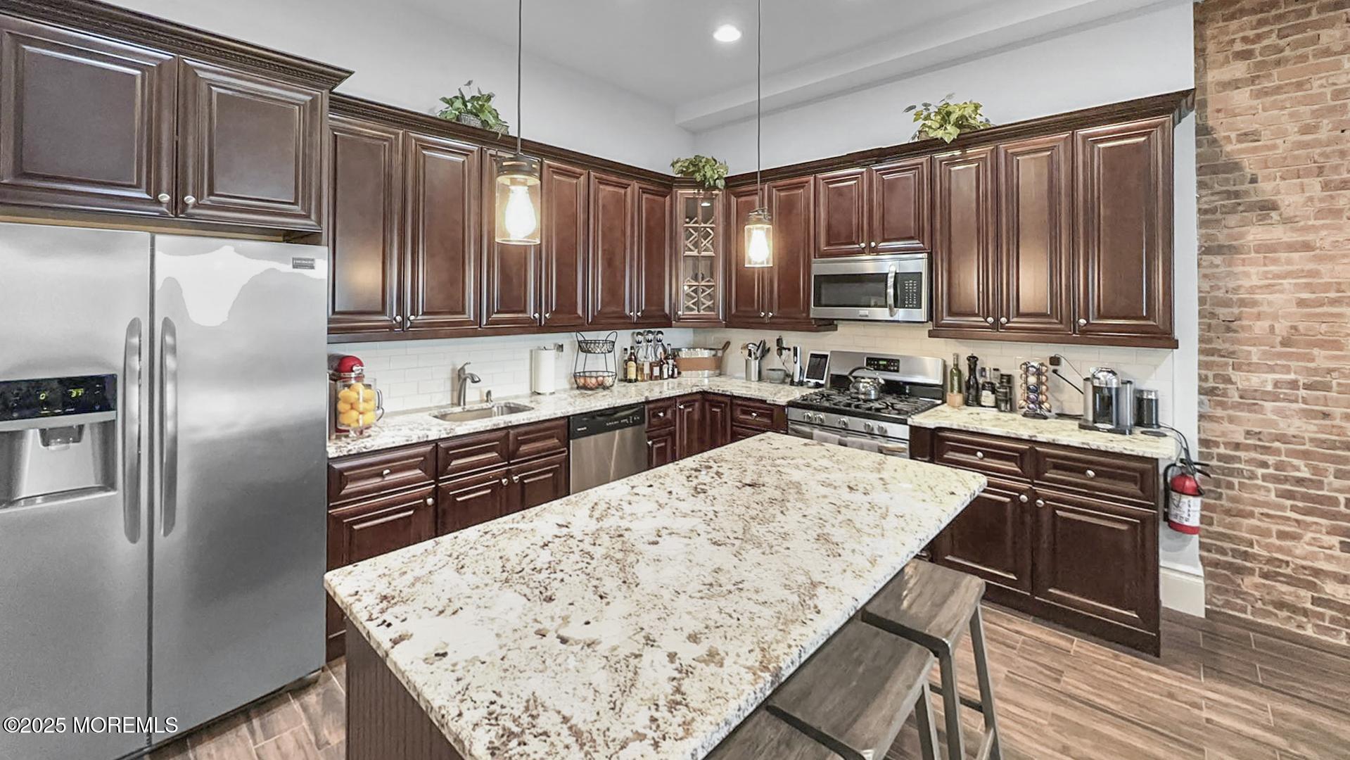 18 Broad Street, Unit 2F Red Bank, NJ 07701 - Photo 6 of 13 a kitchen with a refrigerator sink and cabinets