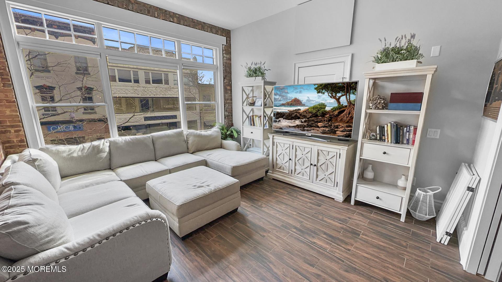 18 Broad Street, Unit 2F Red Bank, NJ 07701 - Photo 7 of 13 a living room with furniture and a floor to ceiling window