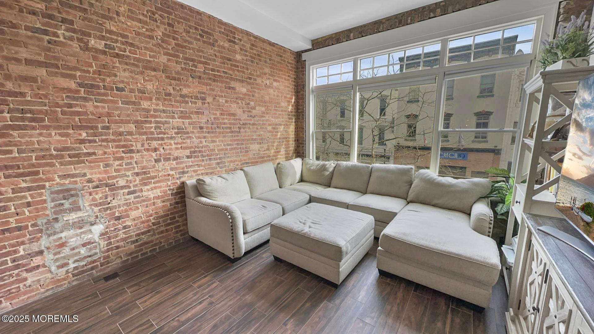 18 Broad Street, Unit 2F Red Bank, NJ 07701 - Photo 8 of 13 a living room with furniture and a large window
