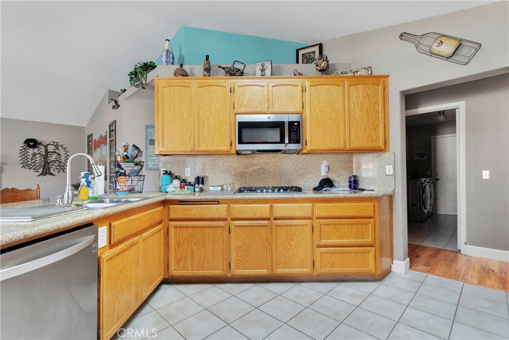 12949 Choco Road Apple Valley, CA 92308 - Photo 15 of 50 a kitchen with a sink cabinets and wooden floor