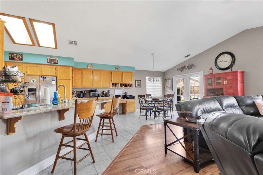 12949 Choco Road Apple Valley, CA 92308 - Photo 18 of 50 a living room with furniture a large window and a clock