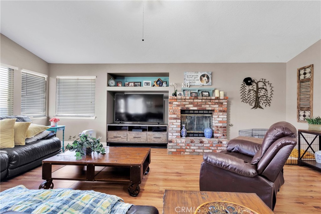 12949 Choco Road Apple Valley, CA 92308 - Photo 20 of 50 a living room with furniture and a flat screen tv