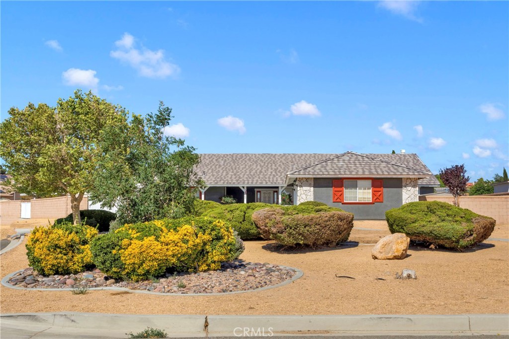 12949 Choco Road Apple Valley, CA 92308 - Photo 2 of 50 a front view of a house with a garden