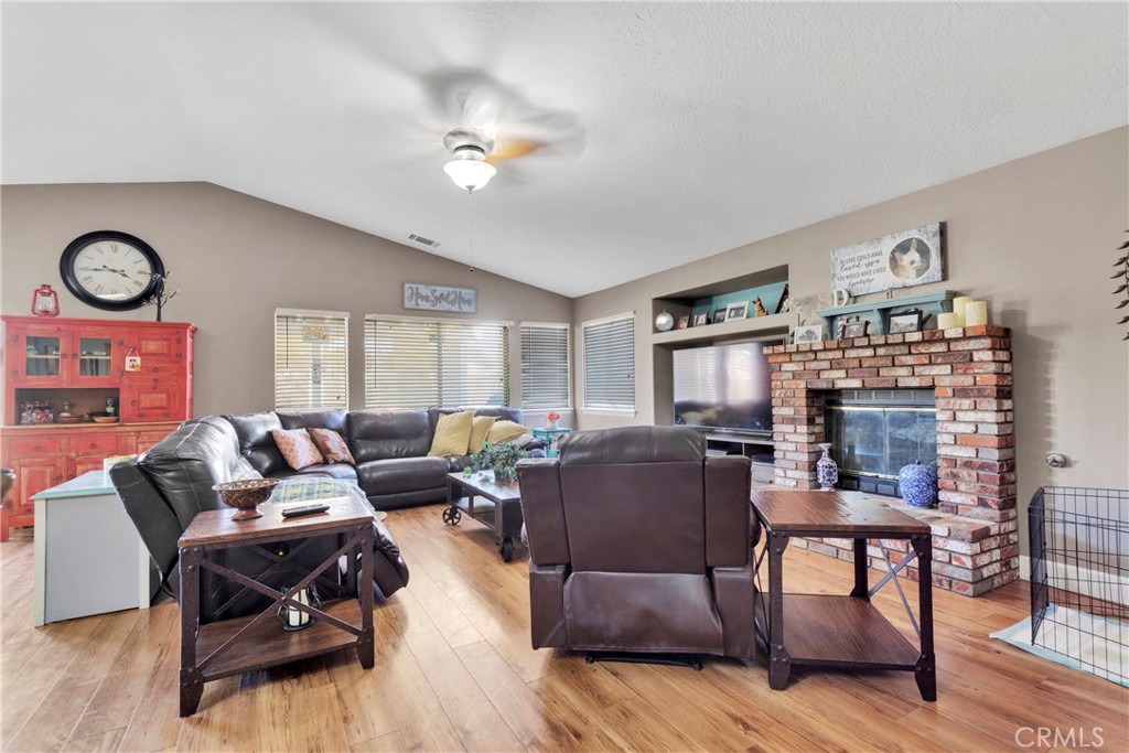 12949 Choco Road Apple Valley, CA 92308 - Photo 21 of 50 a living room with furniture and a wooden floor