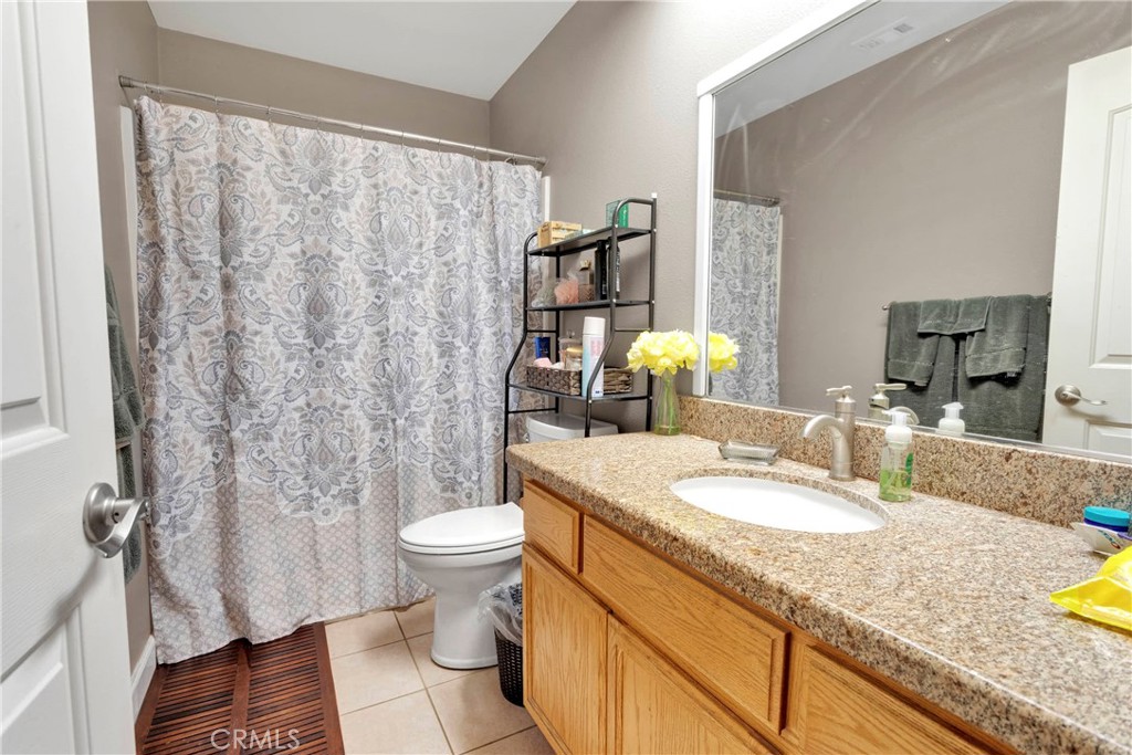 12949 Choco Road Apple Valley, CA 92308 - Photo 22 of 50 a bathroom with a granite countertop sink and a mirror