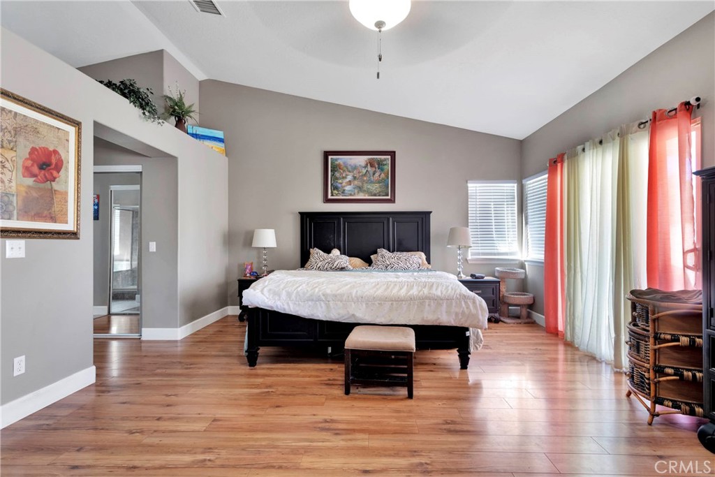 12949 Choco Road Apple Valley, CA 92308 - Photo 23 of 50 a bedroom with a bed and wooden floor