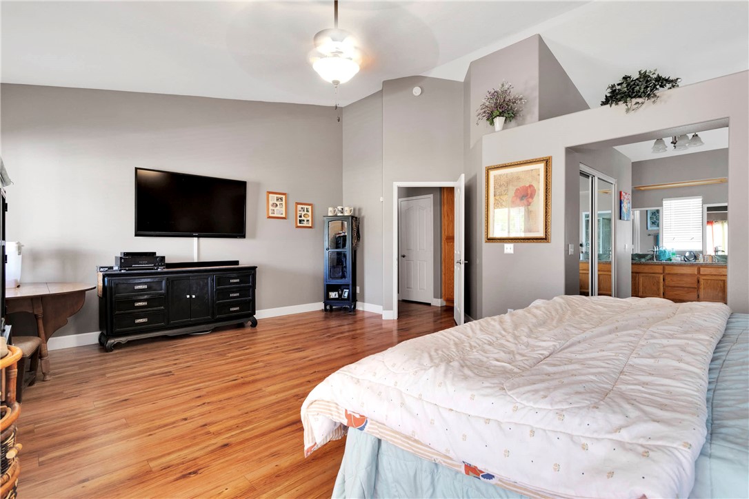 12949 Choco Road Apple Valley, CA 92308 - Photo 25 of 50 a bedroom with a bed and a flat screen tv