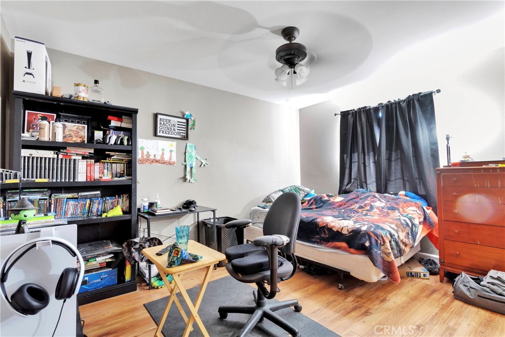 12949 Choco Road Apple Valley, CA 92308 - Photo 29 of 50 a bedroom with furniture and a book shelf
