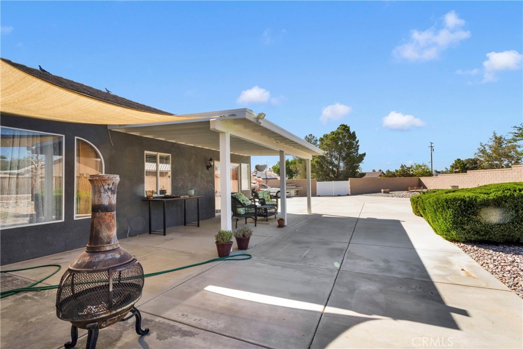 12949 Choco Road Apple Valley, CA 92308 - Photo 35 of 50 a view of a house with backyard porch and sitting area