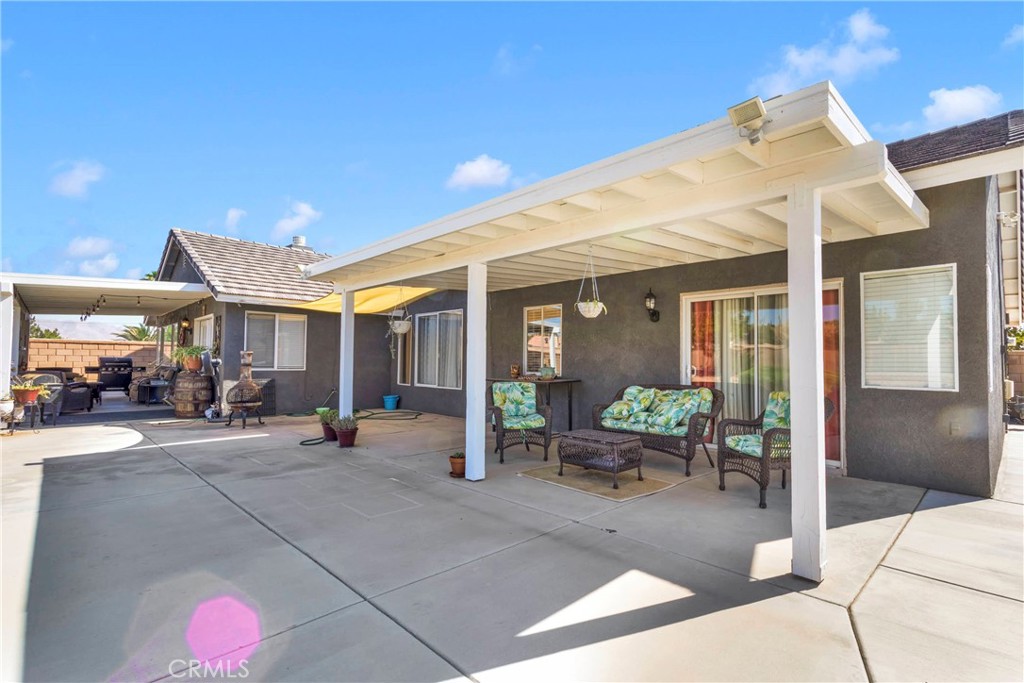 12949 Choco Road Apple Valley, CA 92308 - Photo 36 of 50 a building outdoor space with patio furniture and potted plants