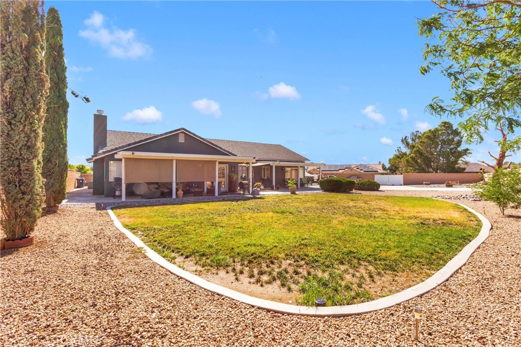 12949 Choco Road Apple Valley, CA 92308 - Photo 37 of 50 a view of a swimming pool with a lounge chairs