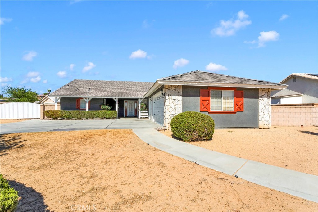12949 Choco Road Apple Valley, CA 92308 - Photo 4 of 50 a front view of a house with a yard