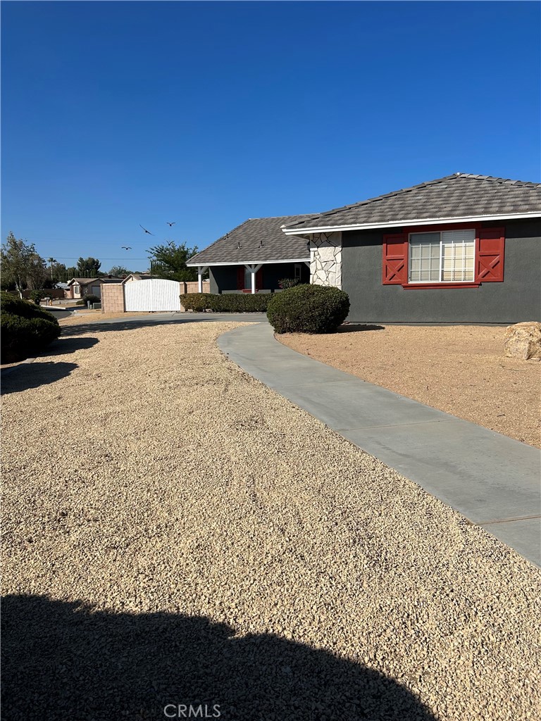 12949 Choco Road Apple Valley, CA 92308 - Photo 6 of 50 a front view of a house with a yard