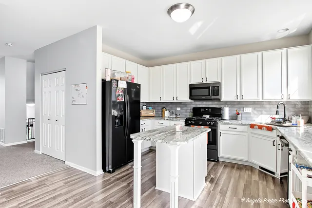 a kitchen with a refrigerator a stove top oven a sink and dishwasher