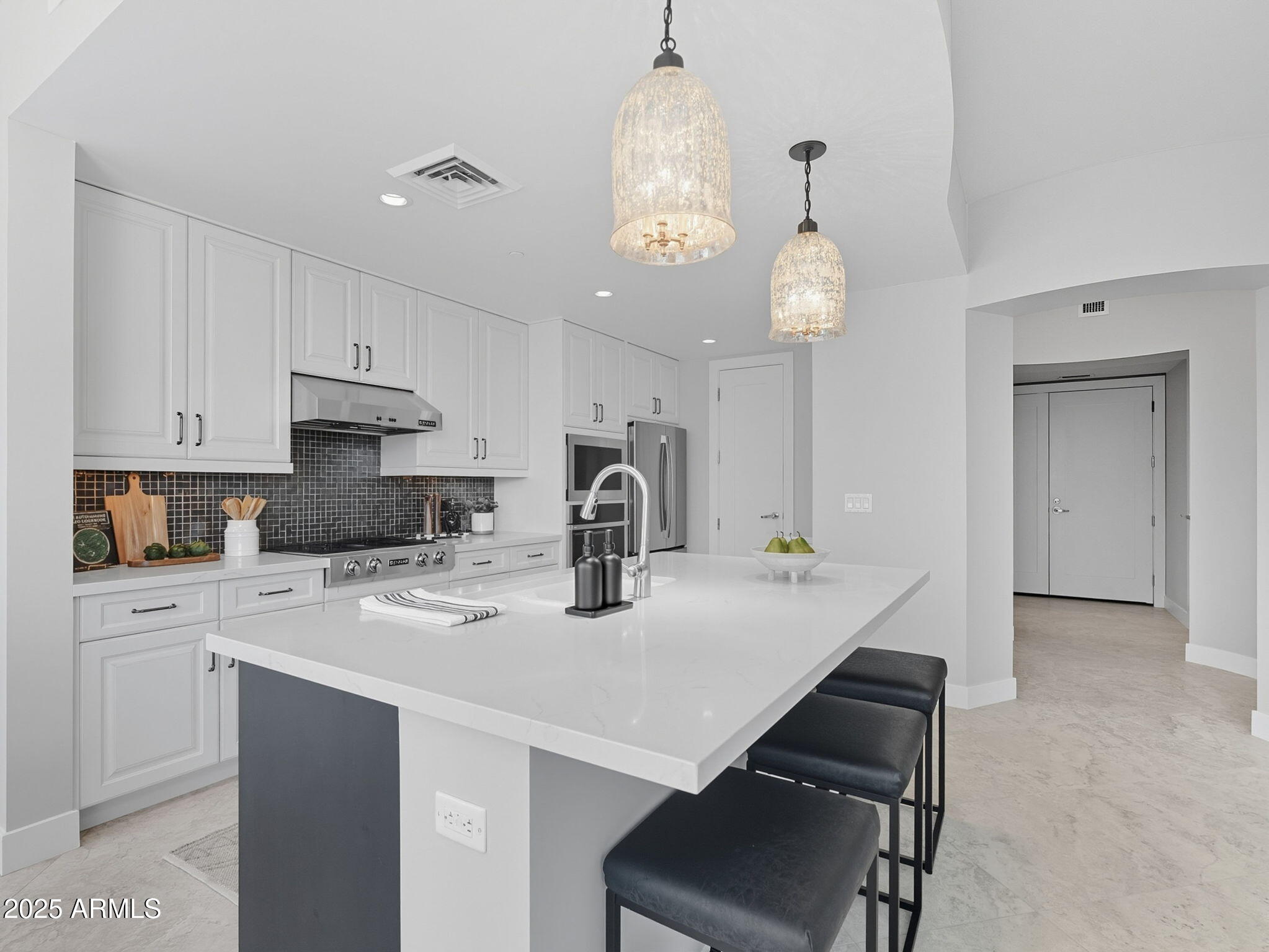 140 East Rio Salado Parkway, Unit 512 Tempe, AZ 85281 - Photo 15 of 41 a kitchen with kitchen island a stove a chandelier and a refrigerator