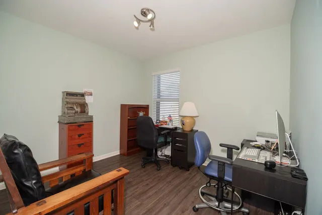 a view of a workspace with furniture and a window