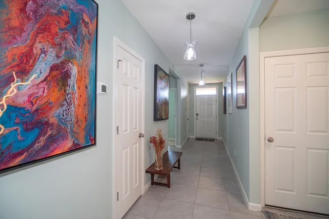 a view of a hallway with paintings on the wall