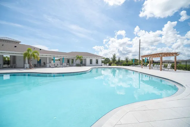 a view of a swimming pool with outdoor seating