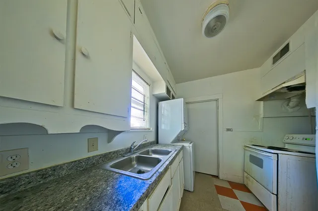 a kitchen with a stove and a sink