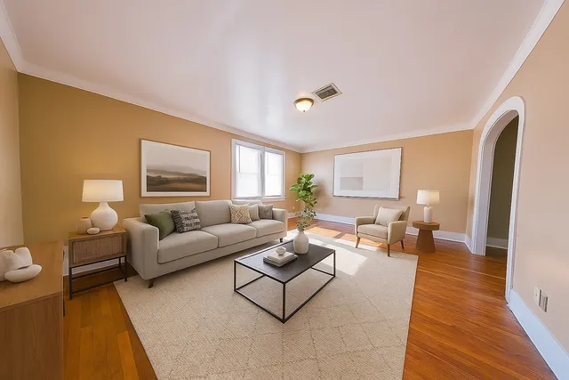 a living room with furniture and a wooden floor